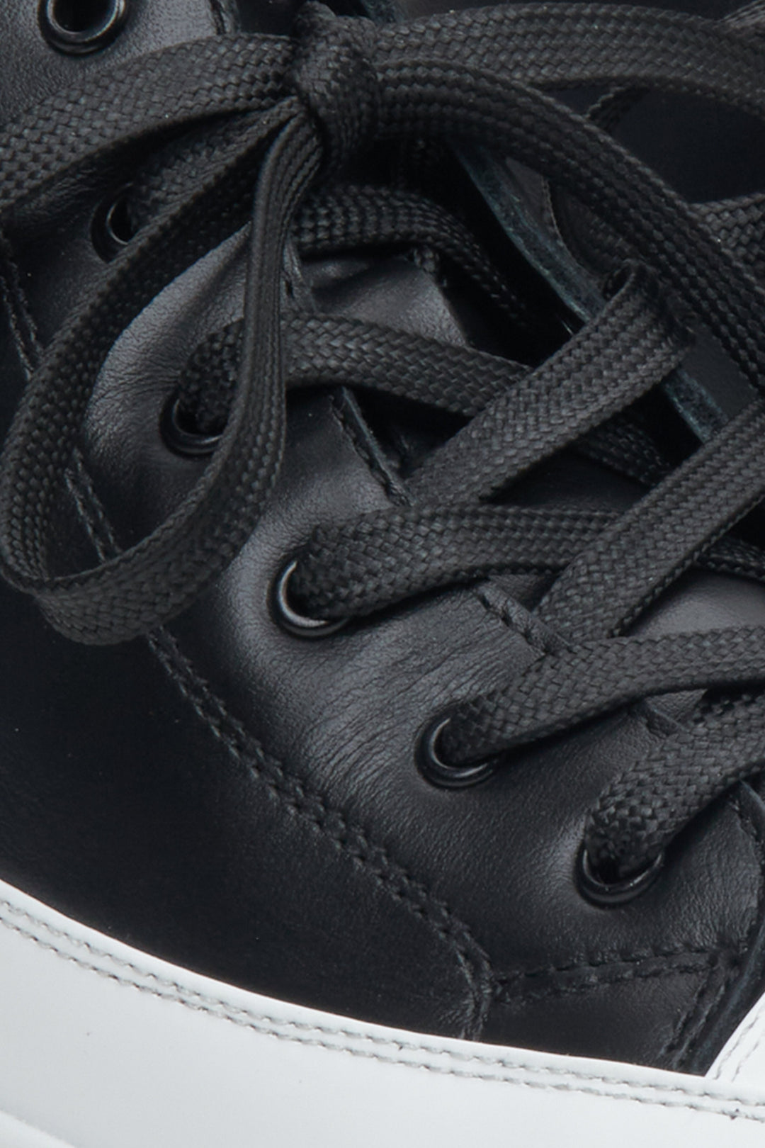 Women's black and white sneakers - close-up on details.