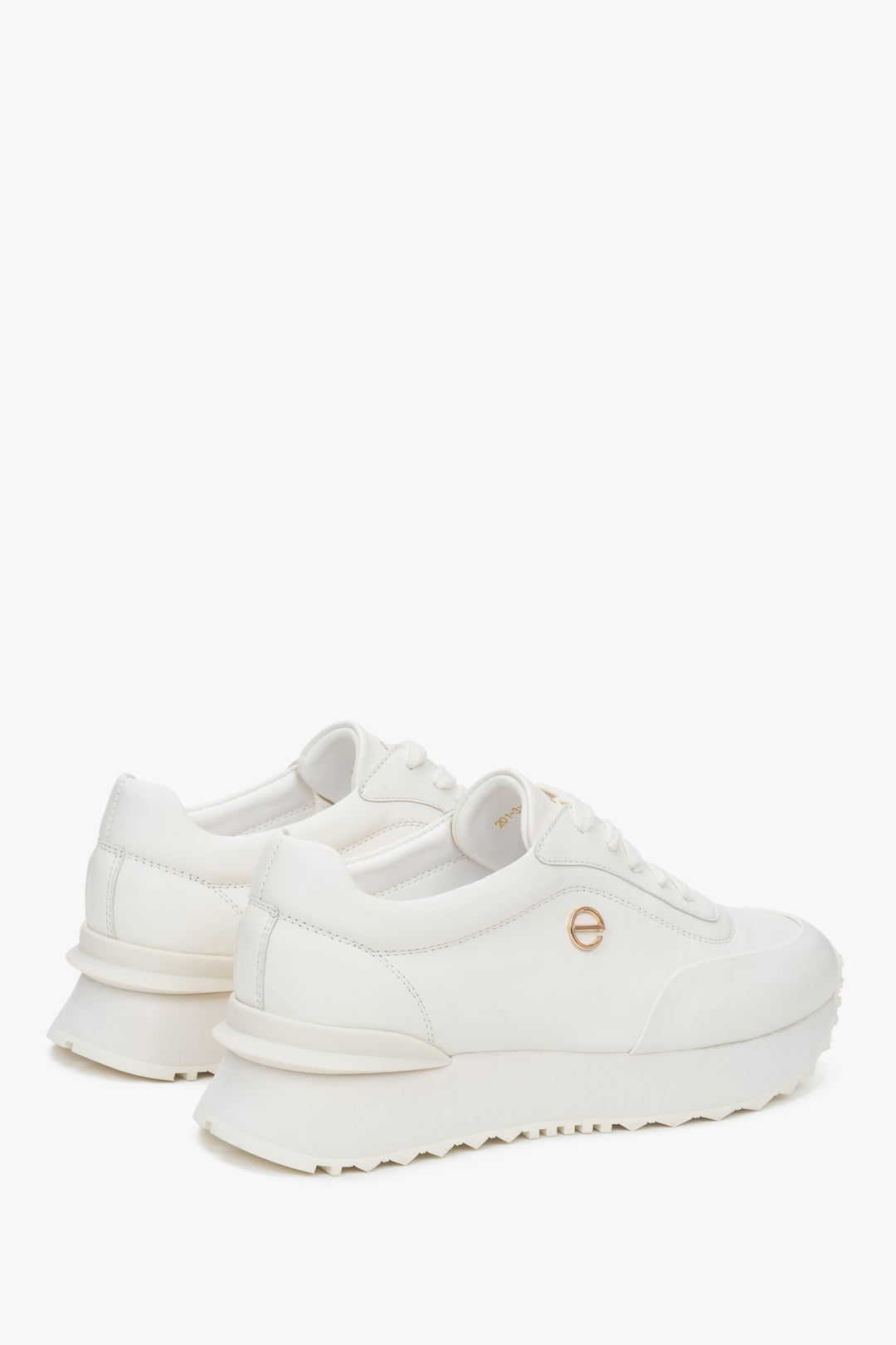 White women's sneakers made of genuine leather with a soft sole.