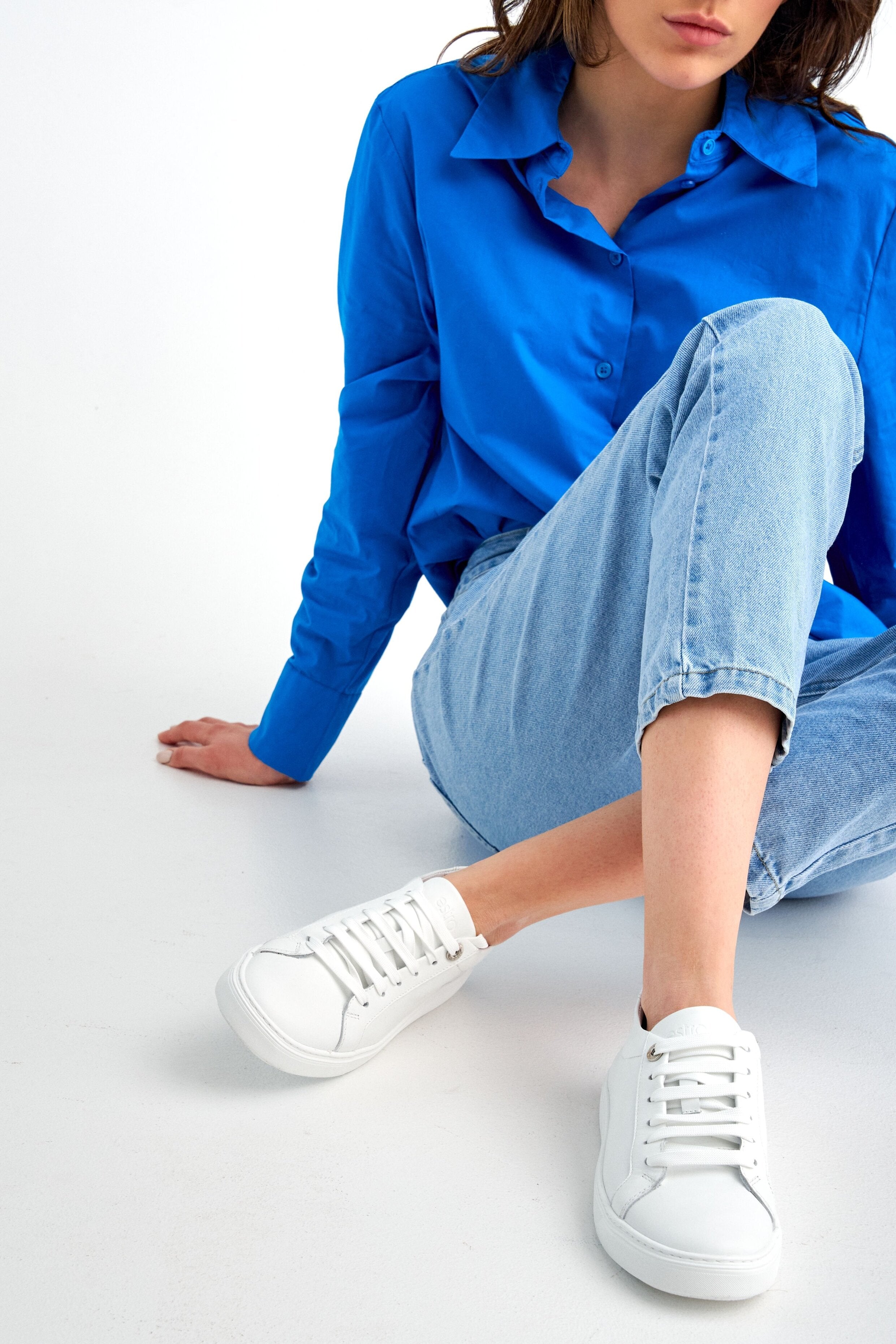 Women's white leather sneakers by Estro with laces.