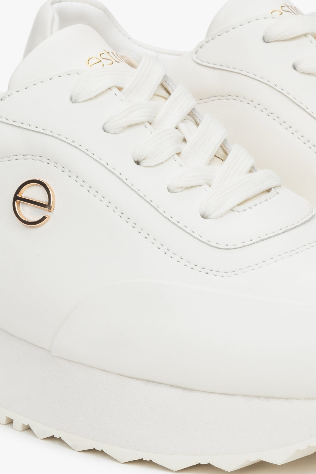 White leather women's sneakers by Estro – close-up on the details.