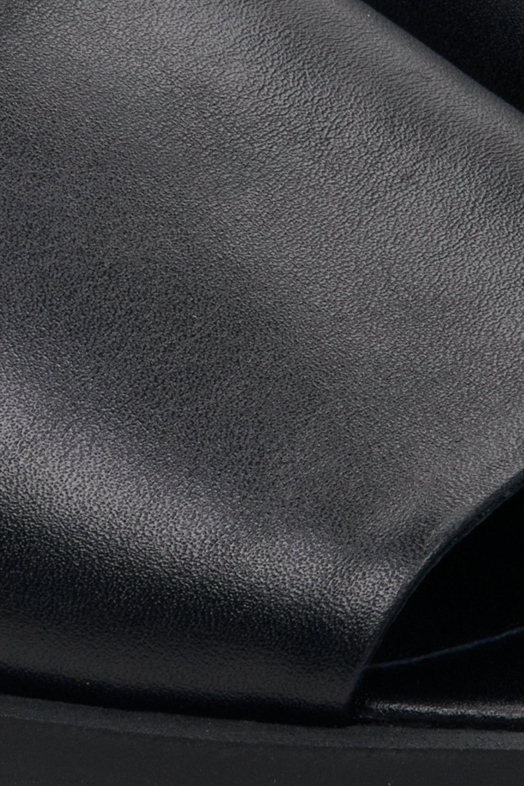 Women's black leather mules by Estro – close-up details.