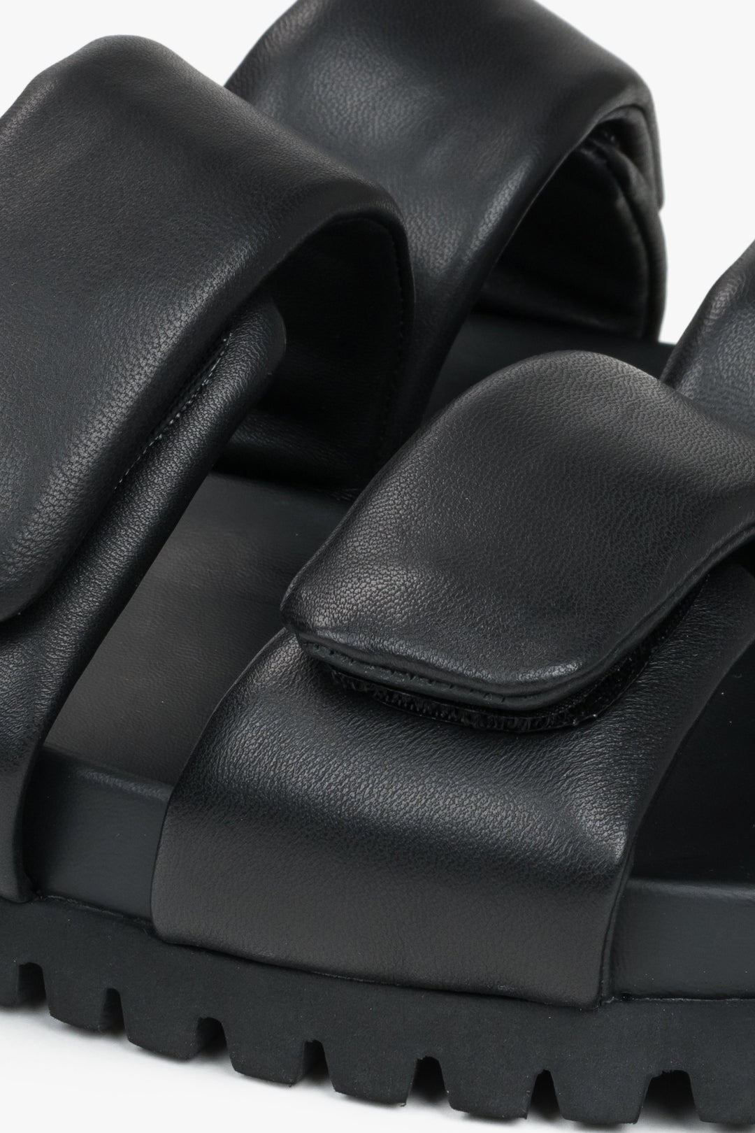 Black leather women's slides by Estro - a combination of genuine leather and soft straps - close-up of the details.