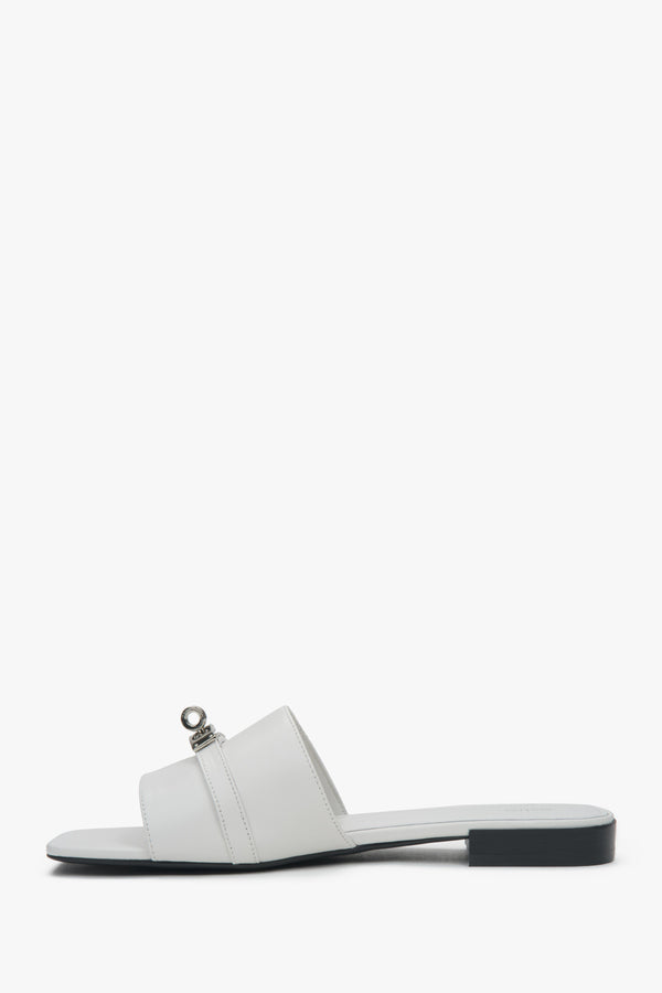 Stylish white Estro women's slide sandals, featuring a subtle silver embellishment and offering comfort thanks to the flat heel.