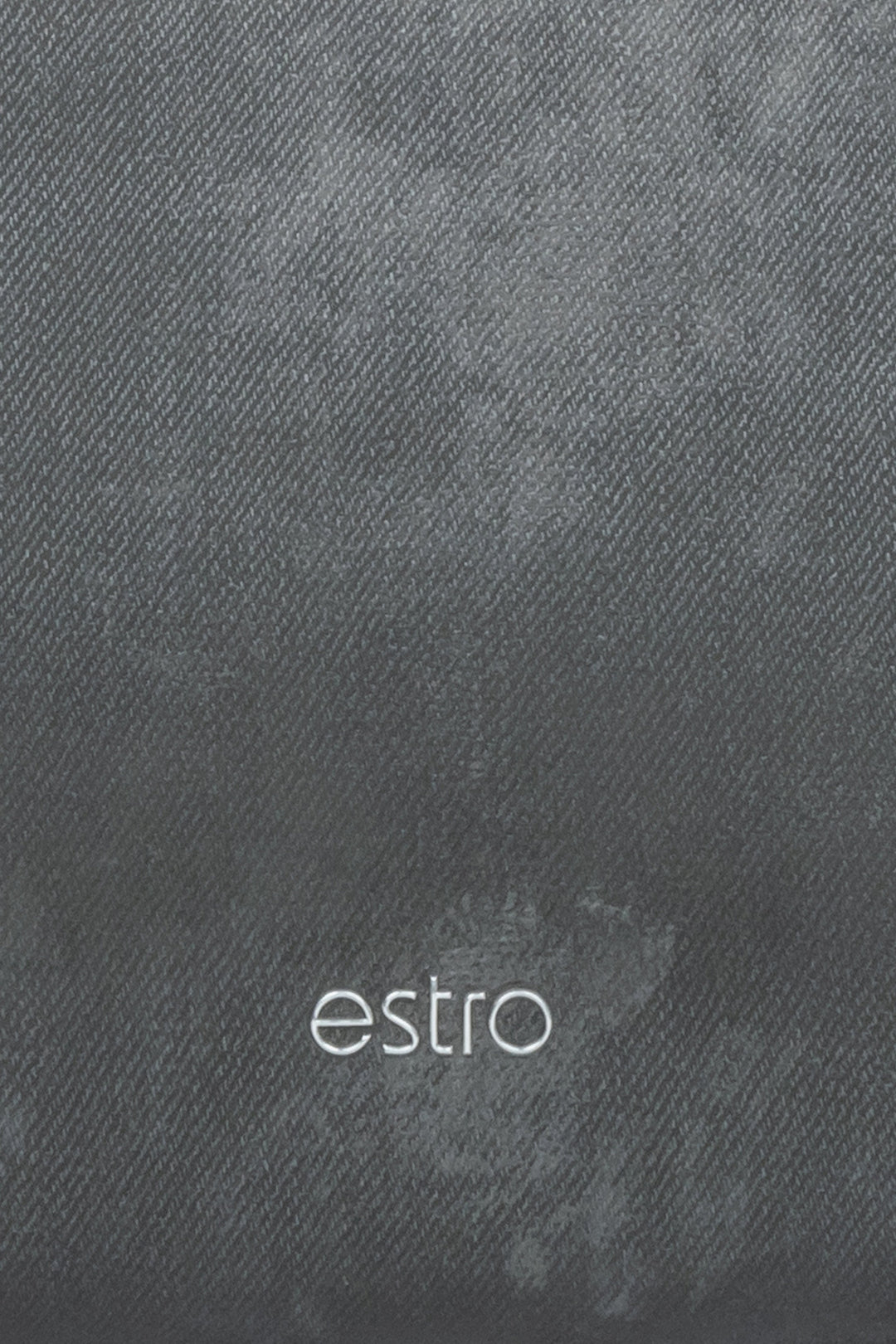 Women's dark grey leather handbag with a marble print  - a close-up on details.