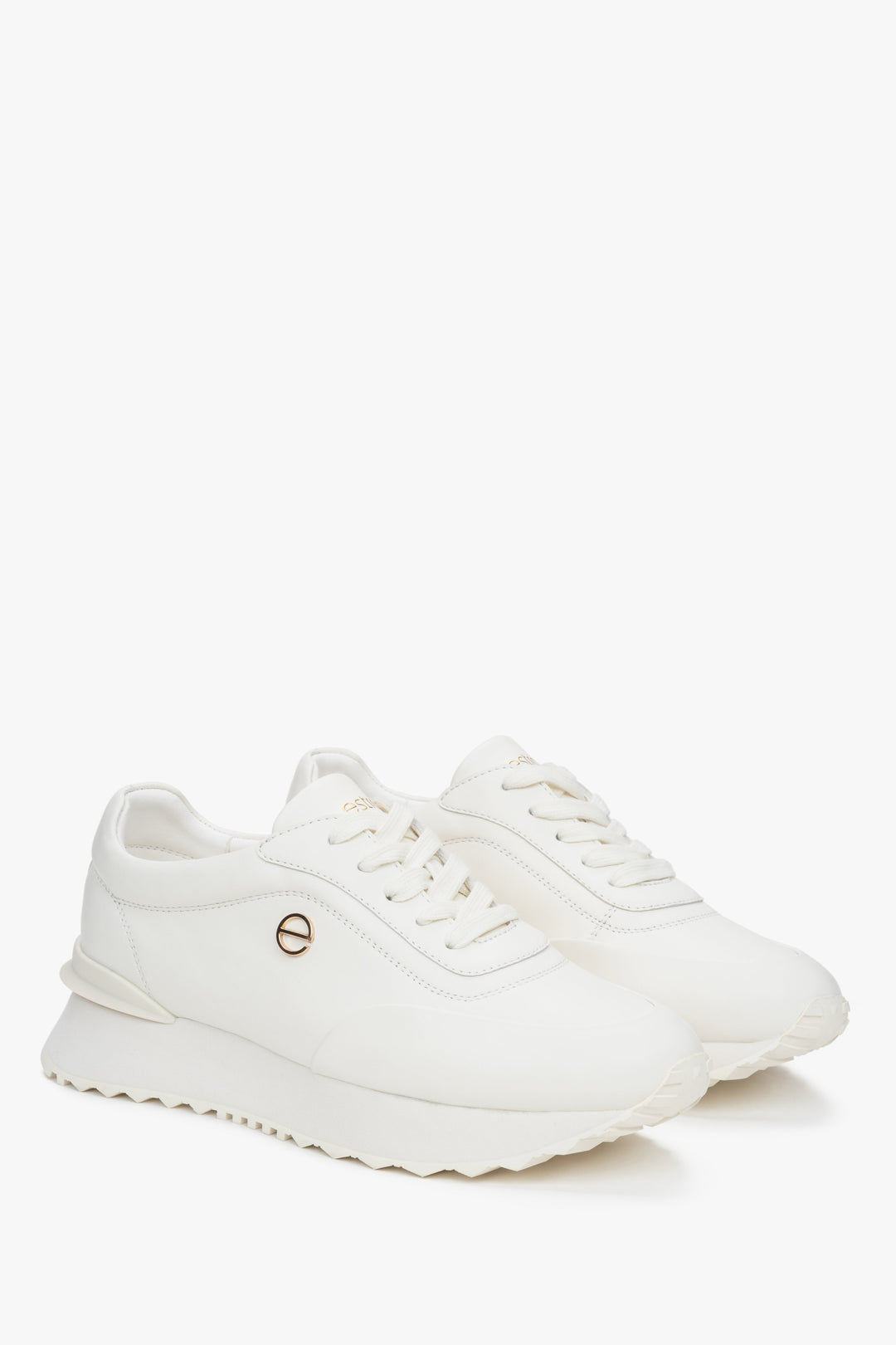 White leather sports shoes for women with a flexible sole by Estro.