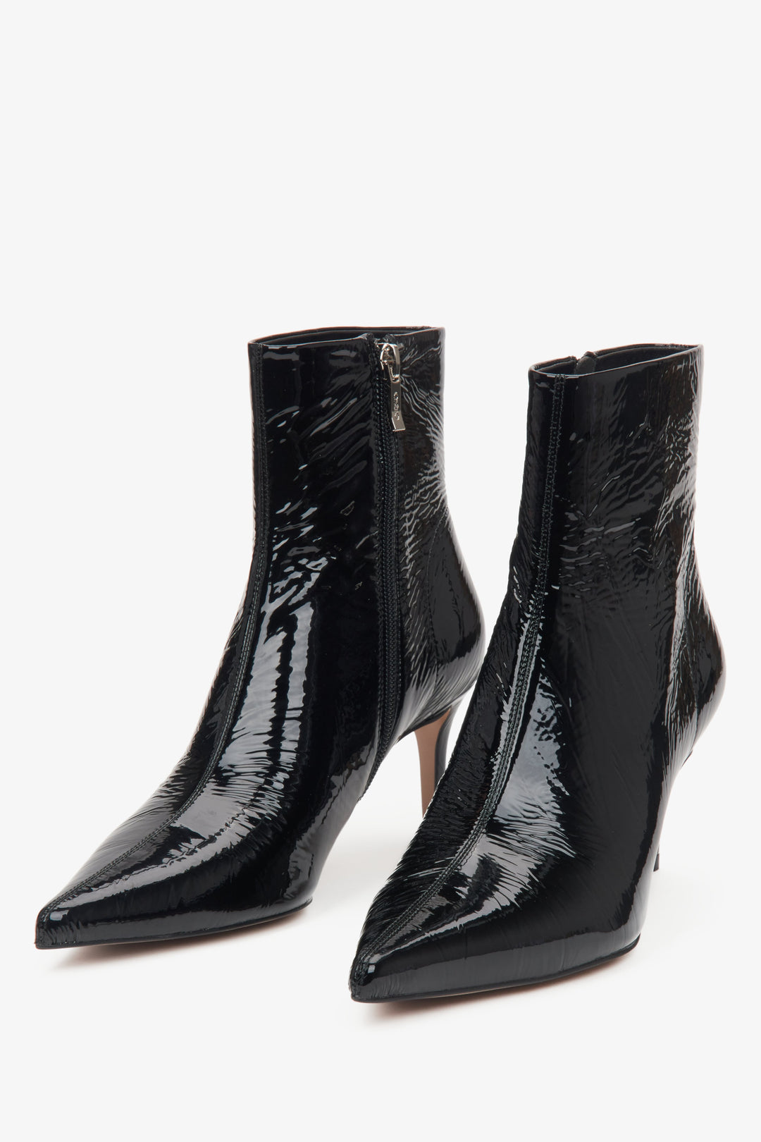 Black patent leather women's ankle boots on a stiletto heel by Estro – close-up of the toe of the shoe.