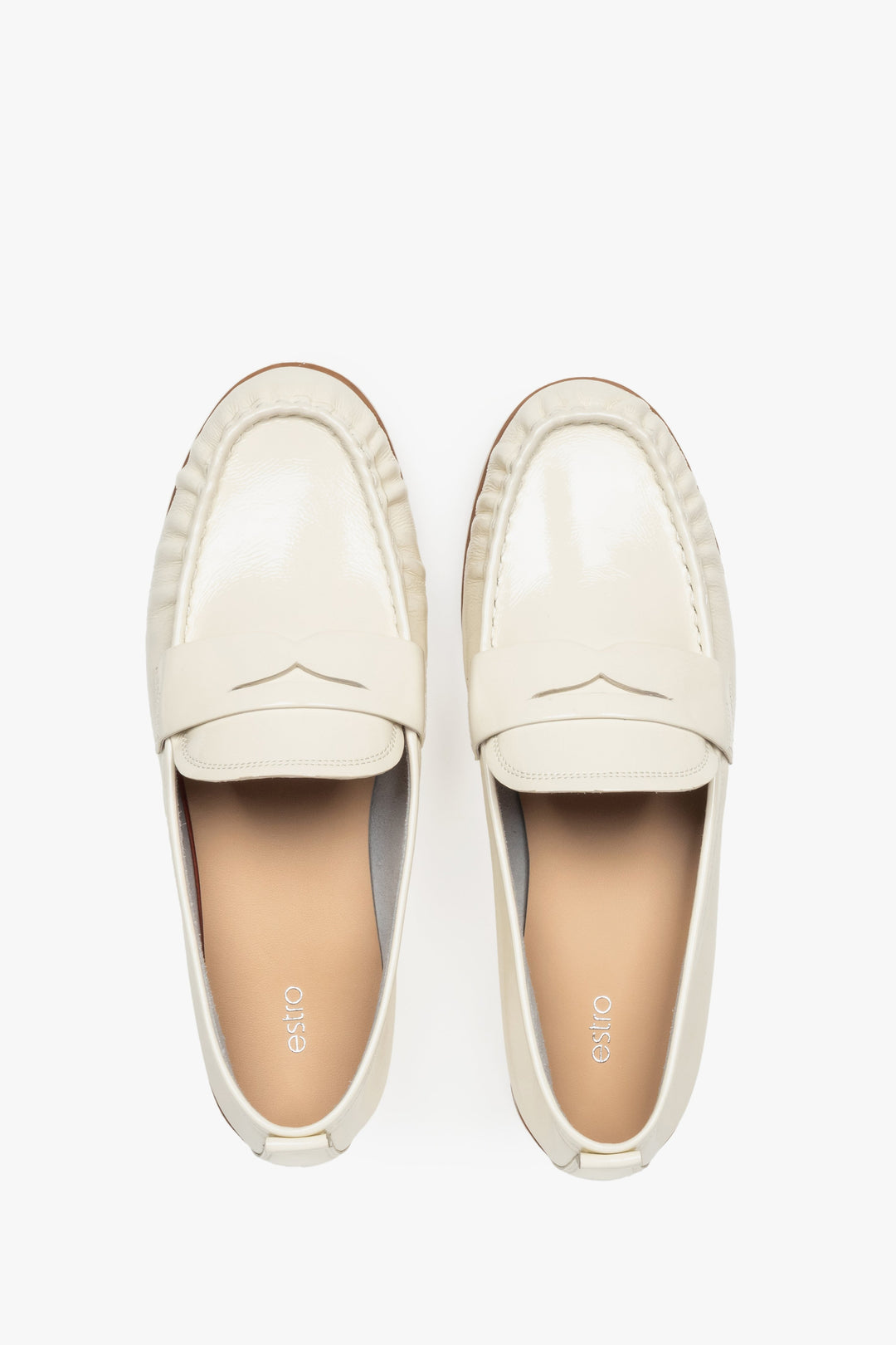 Elegant white women's loafers made of patent leather by Estro.