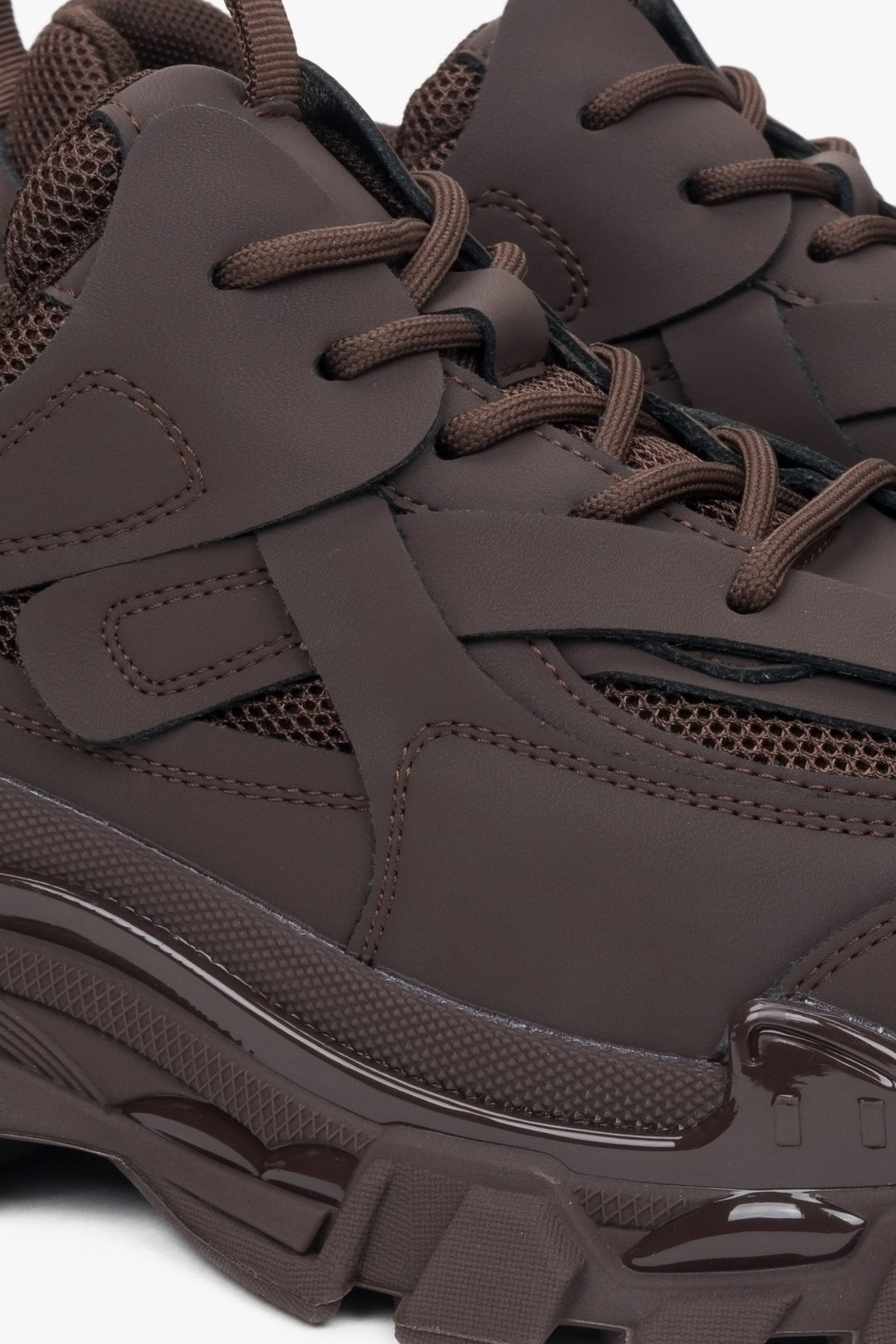 Women's sneakers in dark brown colour made of genuine leather and textile material for spring and autumn - close-up on the lacing system.