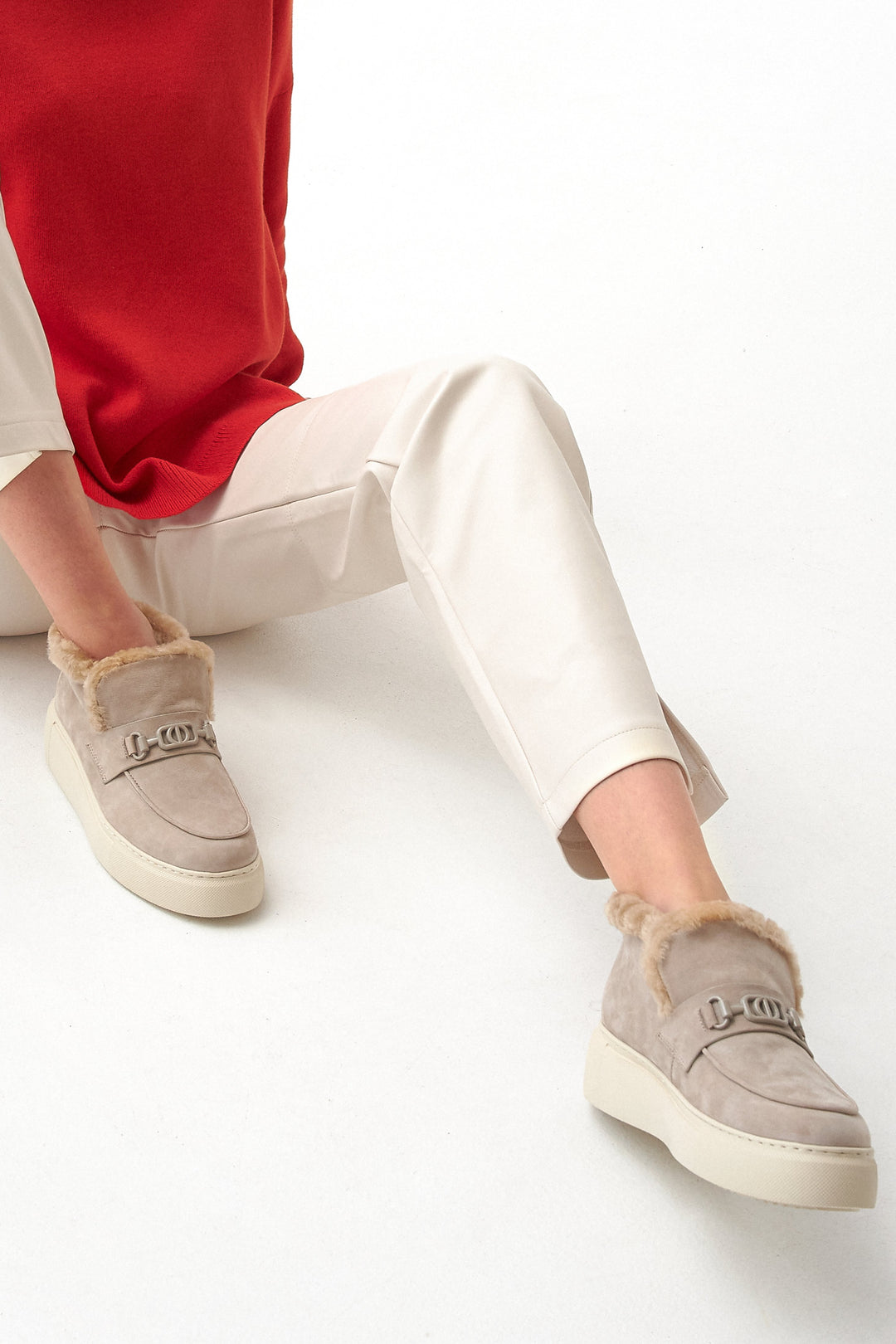 Beige winter low women's boots with natural velour and insulation - presentation on a model.