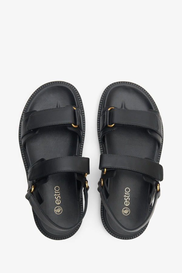 Women's black sandals made of genuine leather with a flexible sole and golden elements.