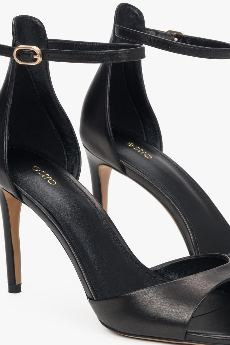 Women's black leather sandals with a high heel by Estro.