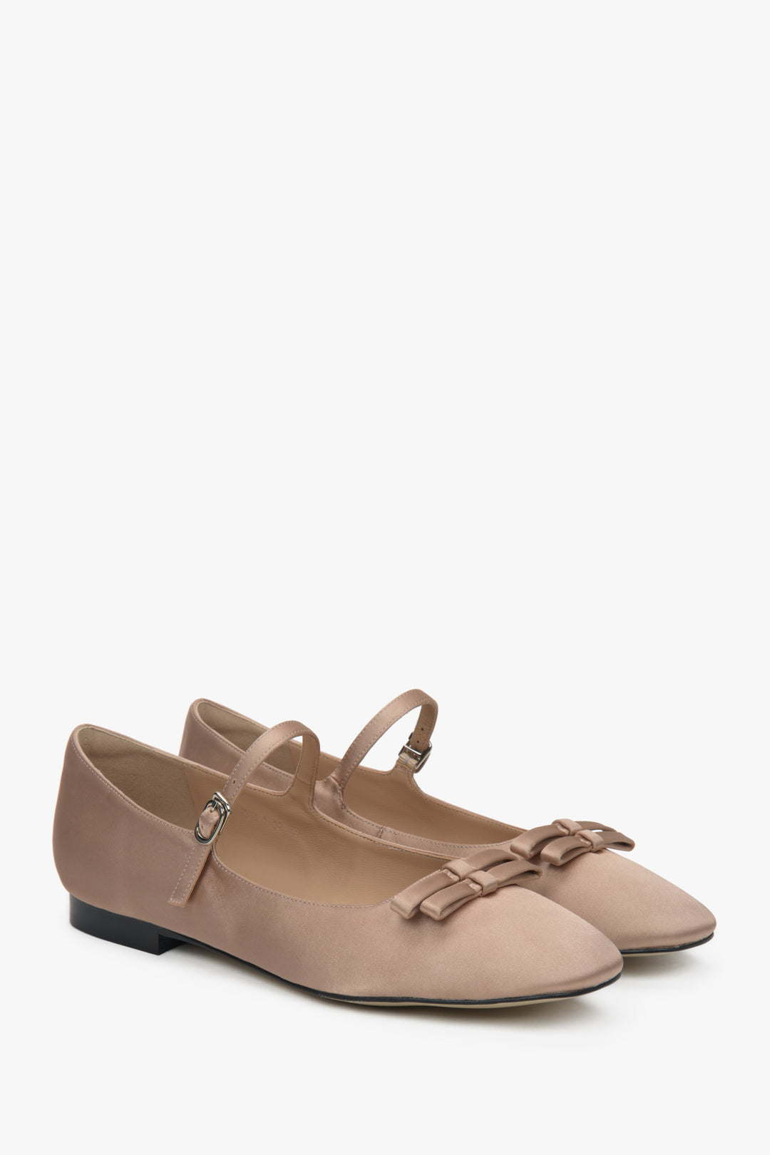Beige textile ballet flats with a buckle.