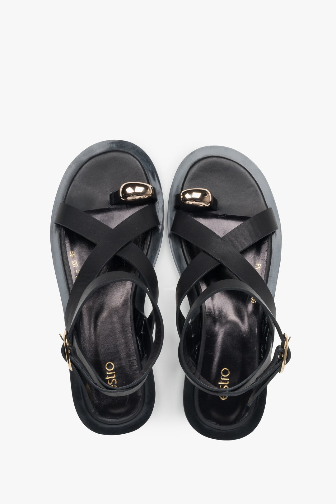 Black leather strappy sandals from Estro, featuring a sleek design and a fashionable toe ring.