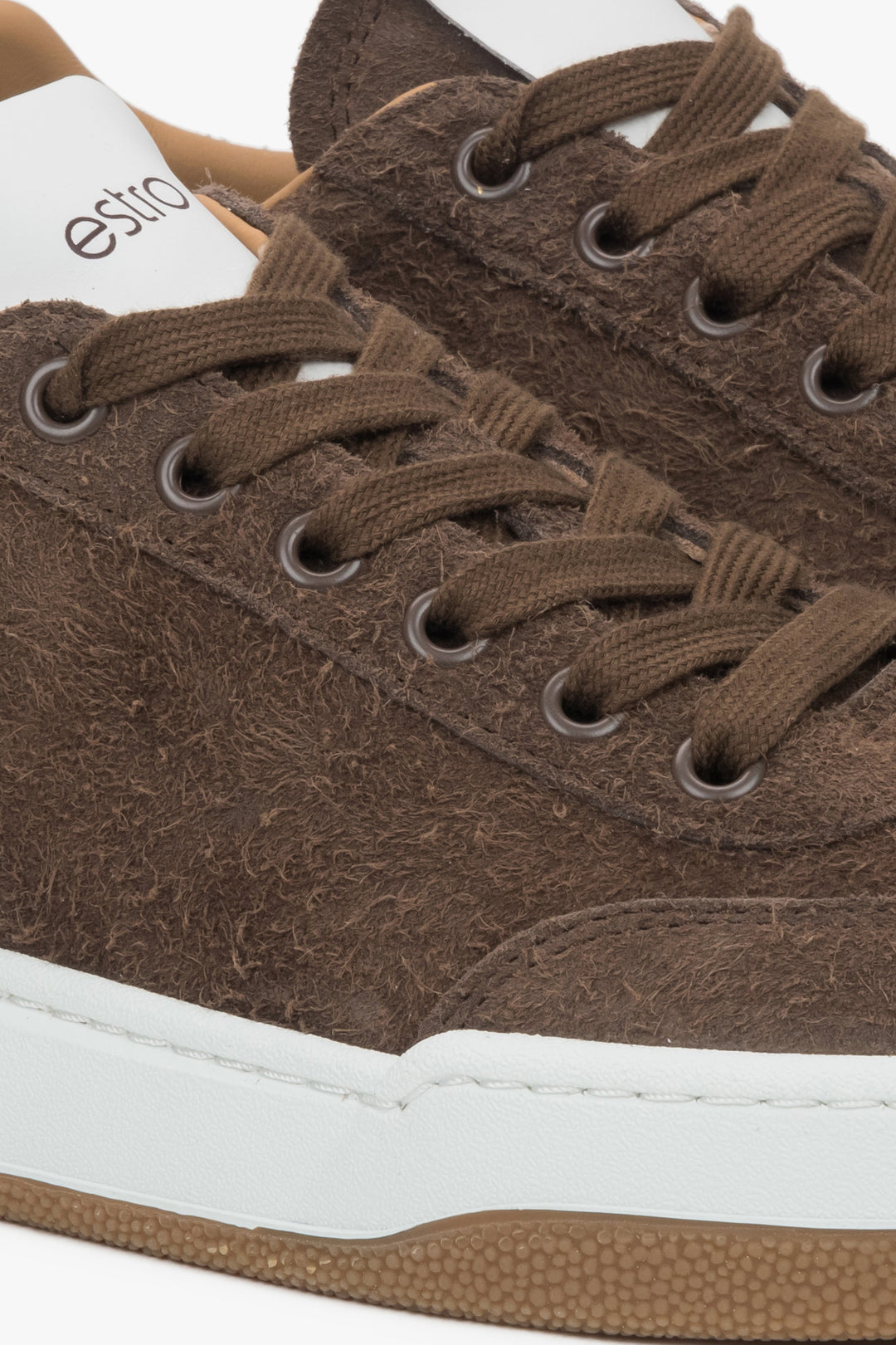 Women's brown sneakers made of genuine velour with a cushioned sole - close-up of the details.
