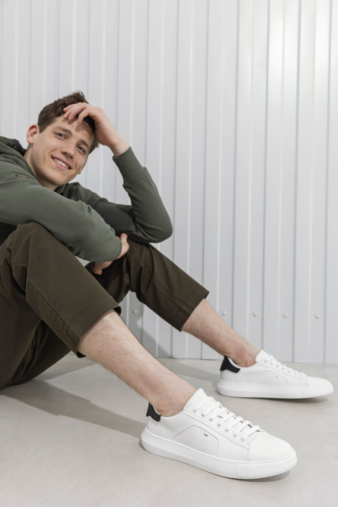 Men's black and white sneakers by Estro - fully-styled product on a model.