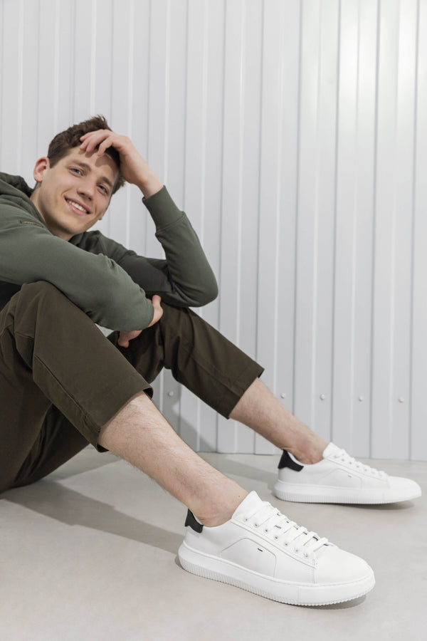 Men's black and white sneakers by Estro - fully-styled product on a model.