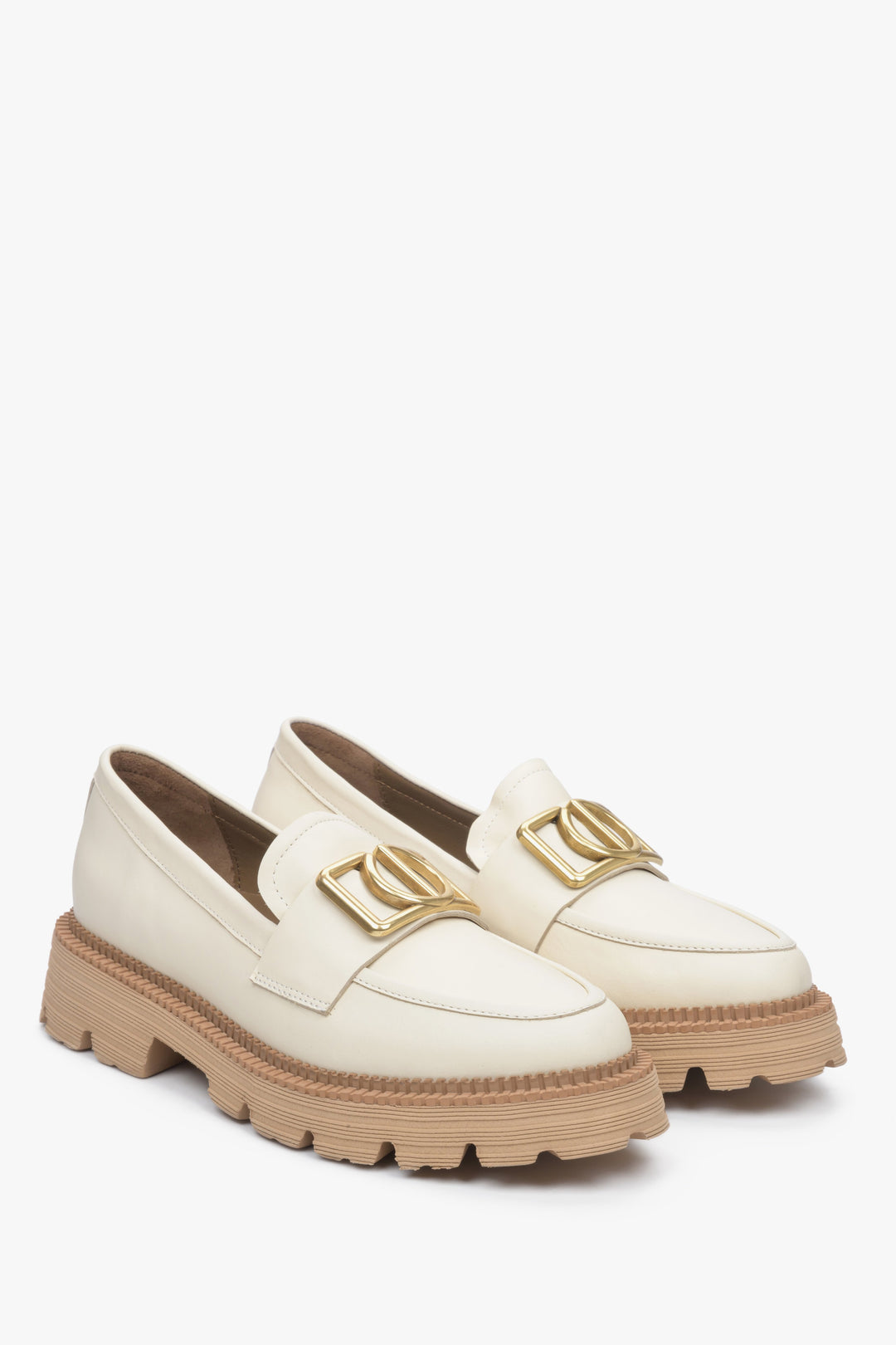 Women's light beige loafers on a chunky platform with gold chain.