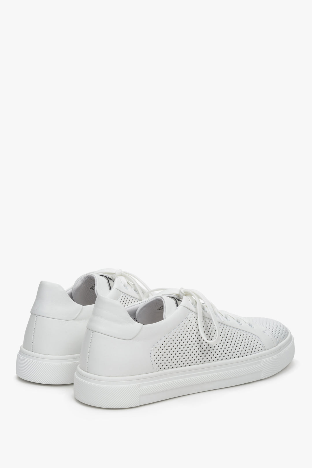 Men's white leather summer sneakers with perforation - close-up on the heel counter and the side line of the shoe.
