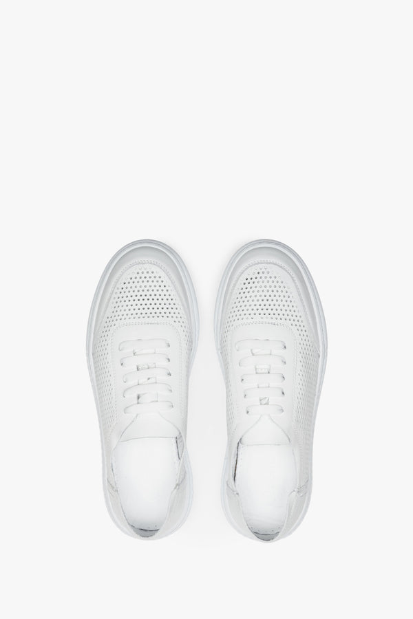 Perforated women's summer sneakers made of white genuine leather - presentation of the footwear from the top.