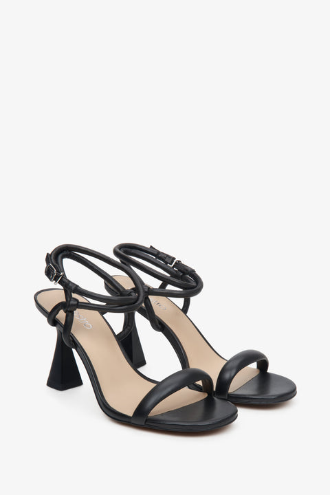 Heeled strappy sandals on a funnel heel in a black colour - close-up on shoe toeline.