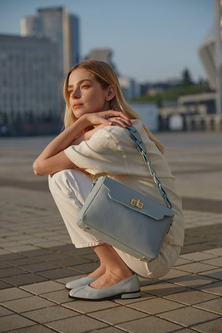 Light blue women's shoulder bag - presentation on a model.