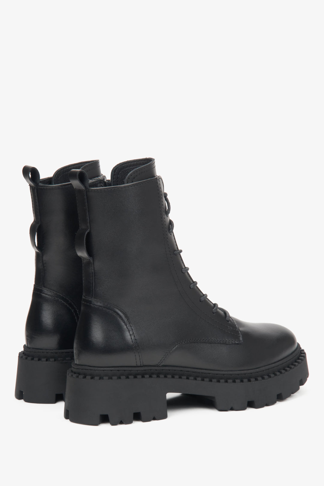 Black leather women's ankle boots by Estro - close-up of the heel and side line of the shoes.