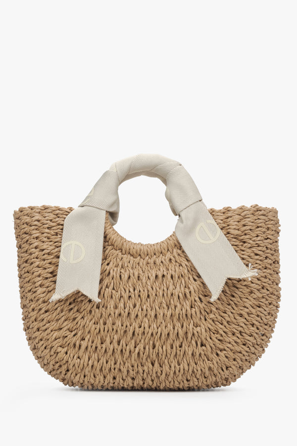 Estro women's woven purse with light beige handle.