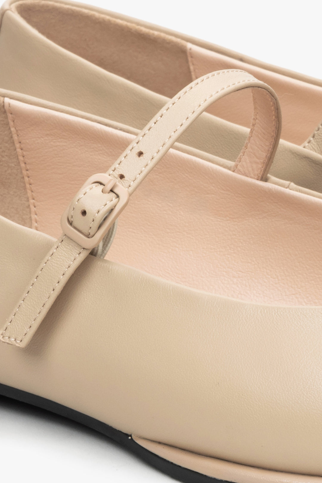 Women's beige ballet flats with a buckle by Estro - close-up on detail.