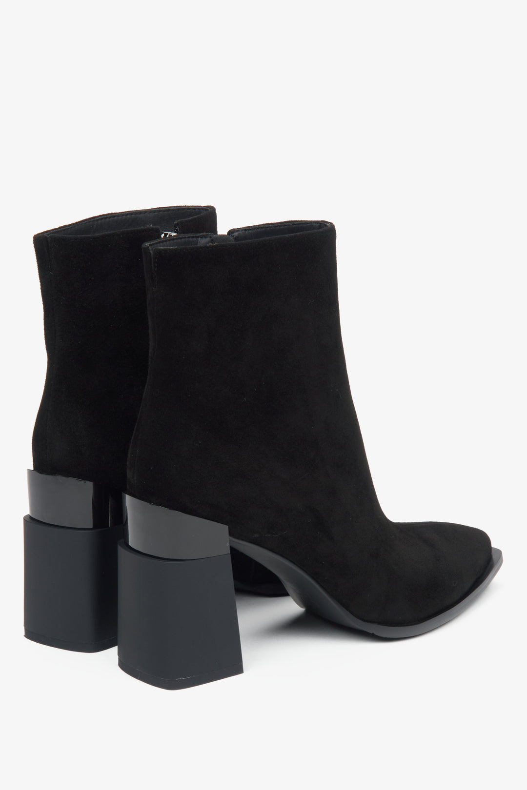 Women's black ankle boots made of genuine velour with insulation and a high heel by Estro - close-up of the heel and side line of the shoes.