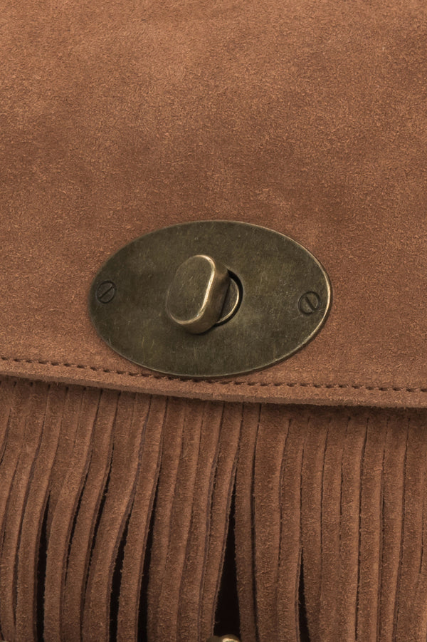 The bag styled with the adjustable strap, demonstrating versatile wear as a shoulder or crossbody option.