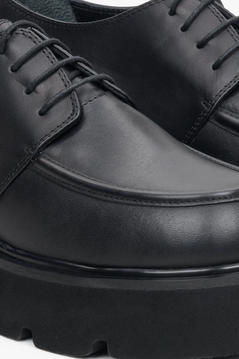 Women's black leather lace-up shoes by Estro - close-up on details.