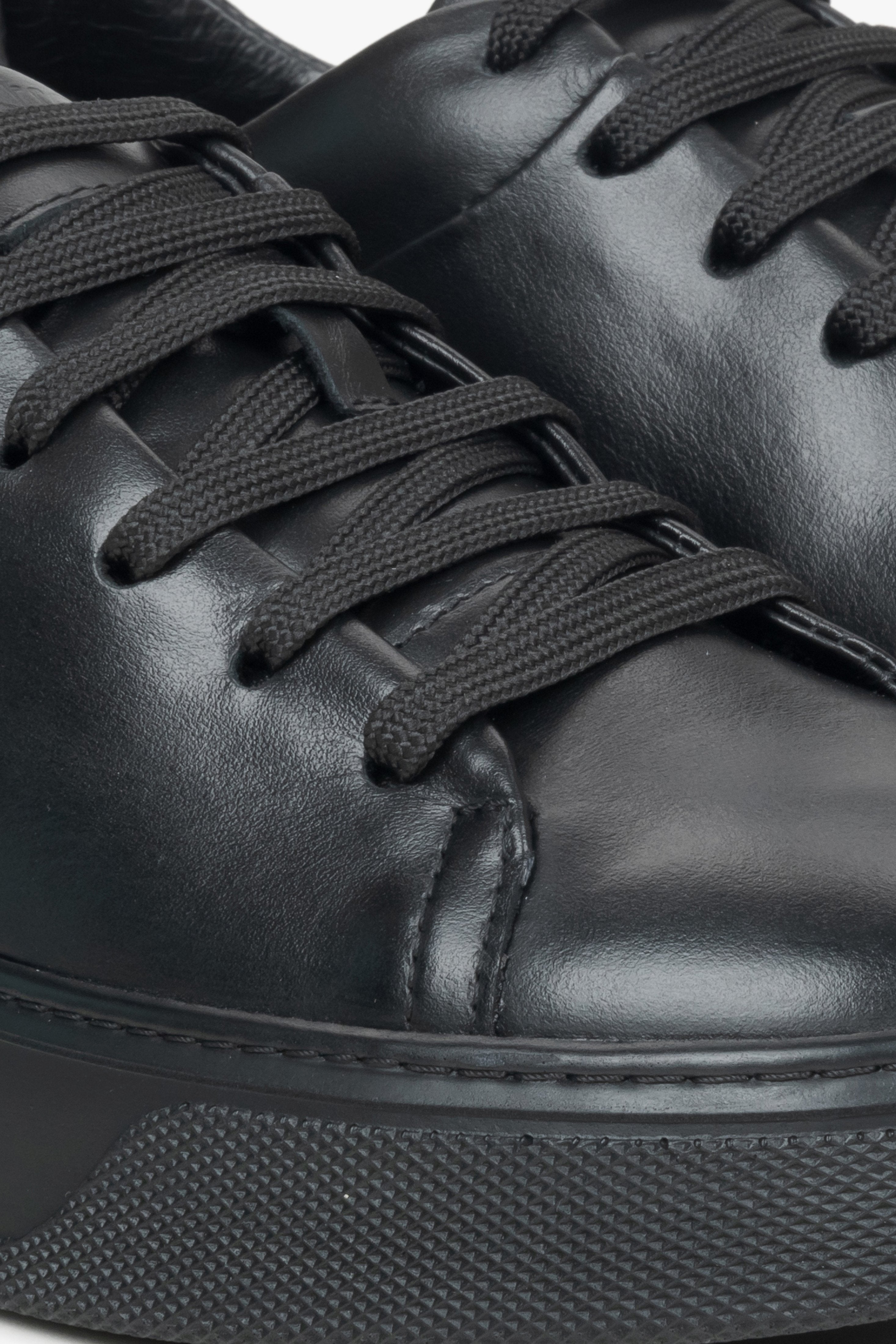 Close-up on details of black women's sneakers made of genuine leather Estro.