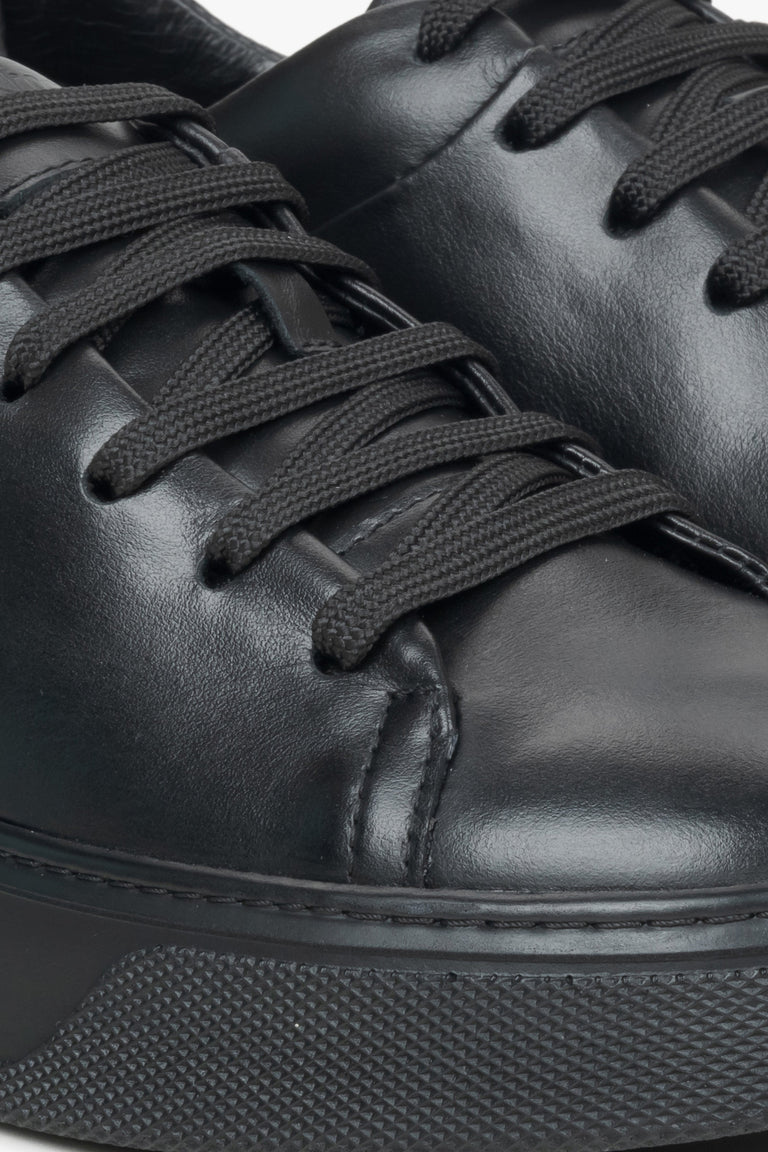 Close-up on details of black women's sneakers made of genuine leather Estro.