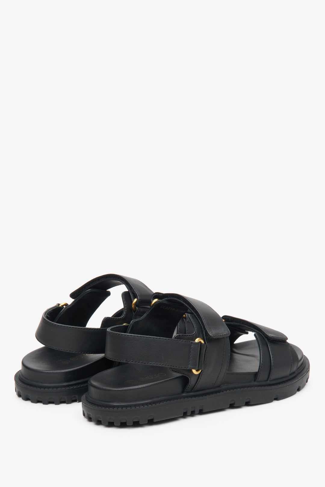 Women's black leather  sandals with a soft sole and gold elements - close-up on the side and heel line.