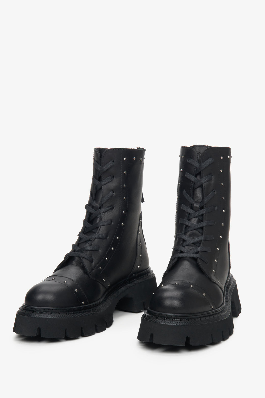 Women's black leather ankle boots with silver studs.