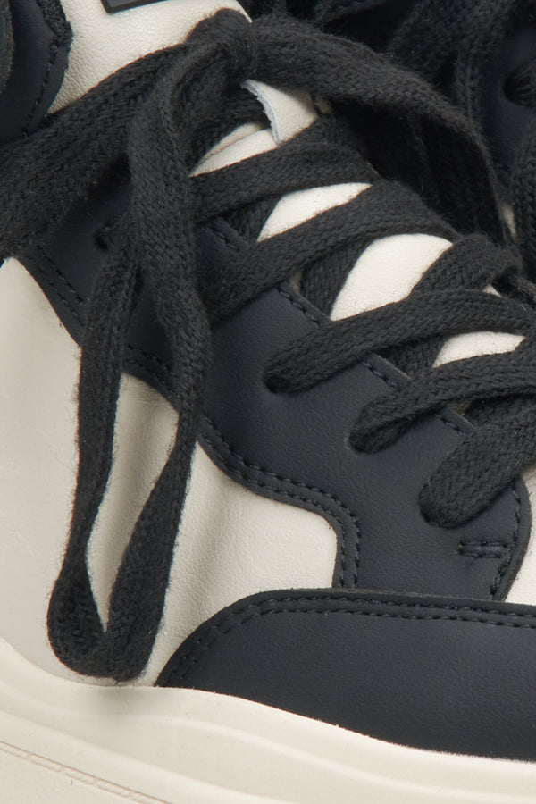 High-top women's sneakers made of natural leather in beige-black by Estro - close-up on details.