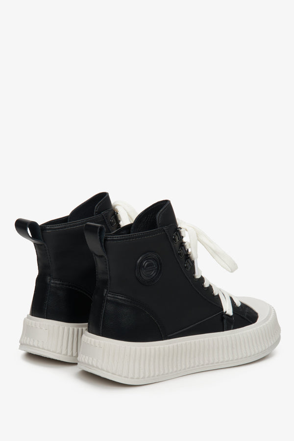 Women's black sneakers with the visible Estro brand logo.