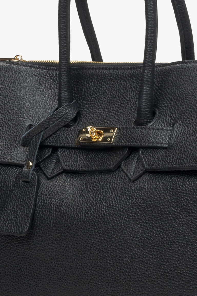 Women's black handy satchel by Estro - close-up on the detail.