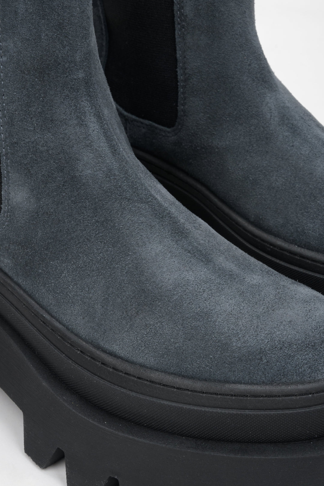 Stylish women's grey ankle boots on a thick sole by Estro - close-up on the rounded toe of the model.
