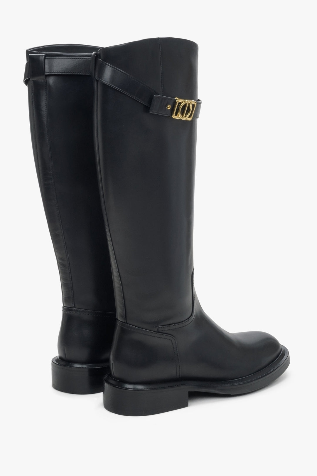 Women's black leather boots by Estro with a decorative strap - close-up on the back and side of the shoe.