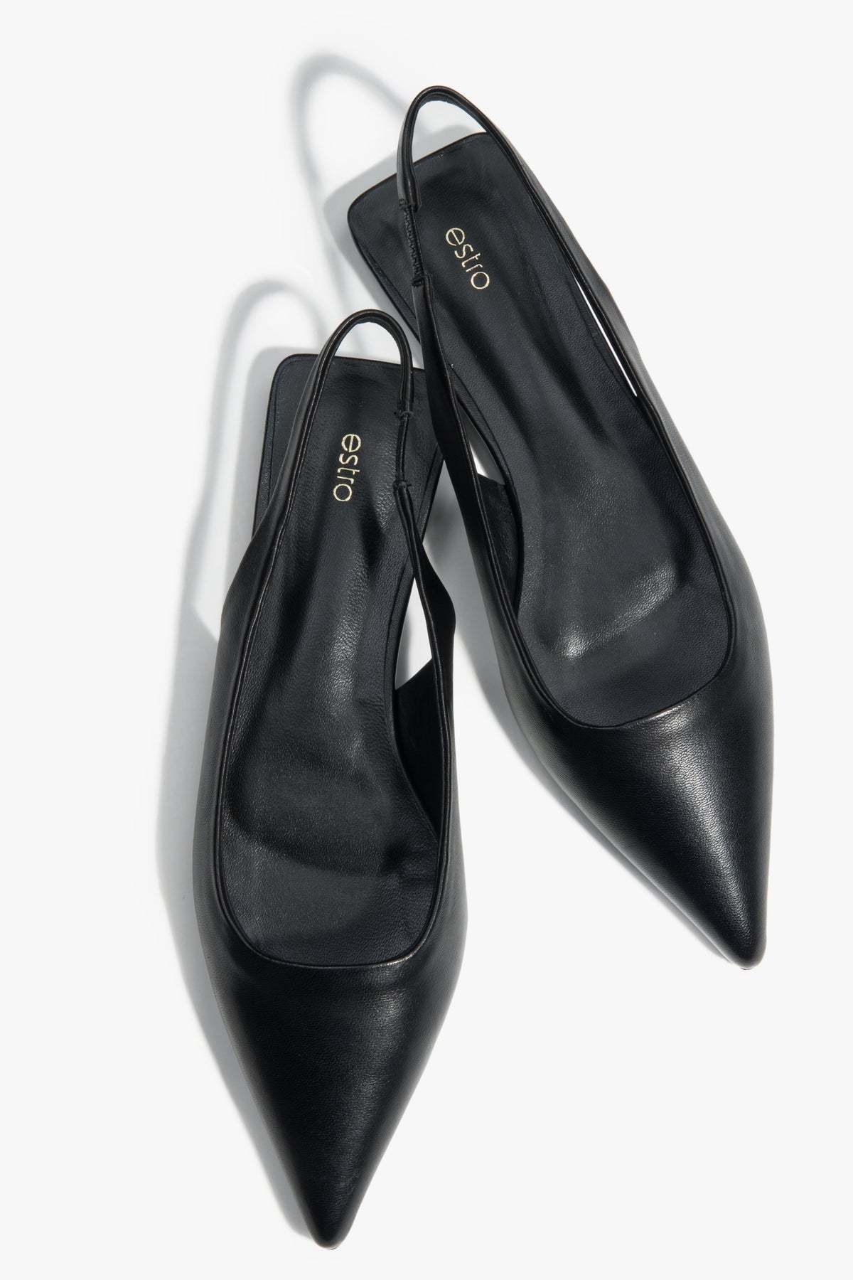 Black slingback sandals with a pointed toe and flat heel.