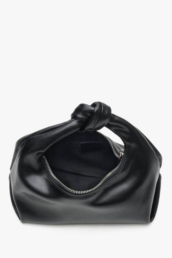 Close-up of the interior of the small black women's evening bag by Estro.