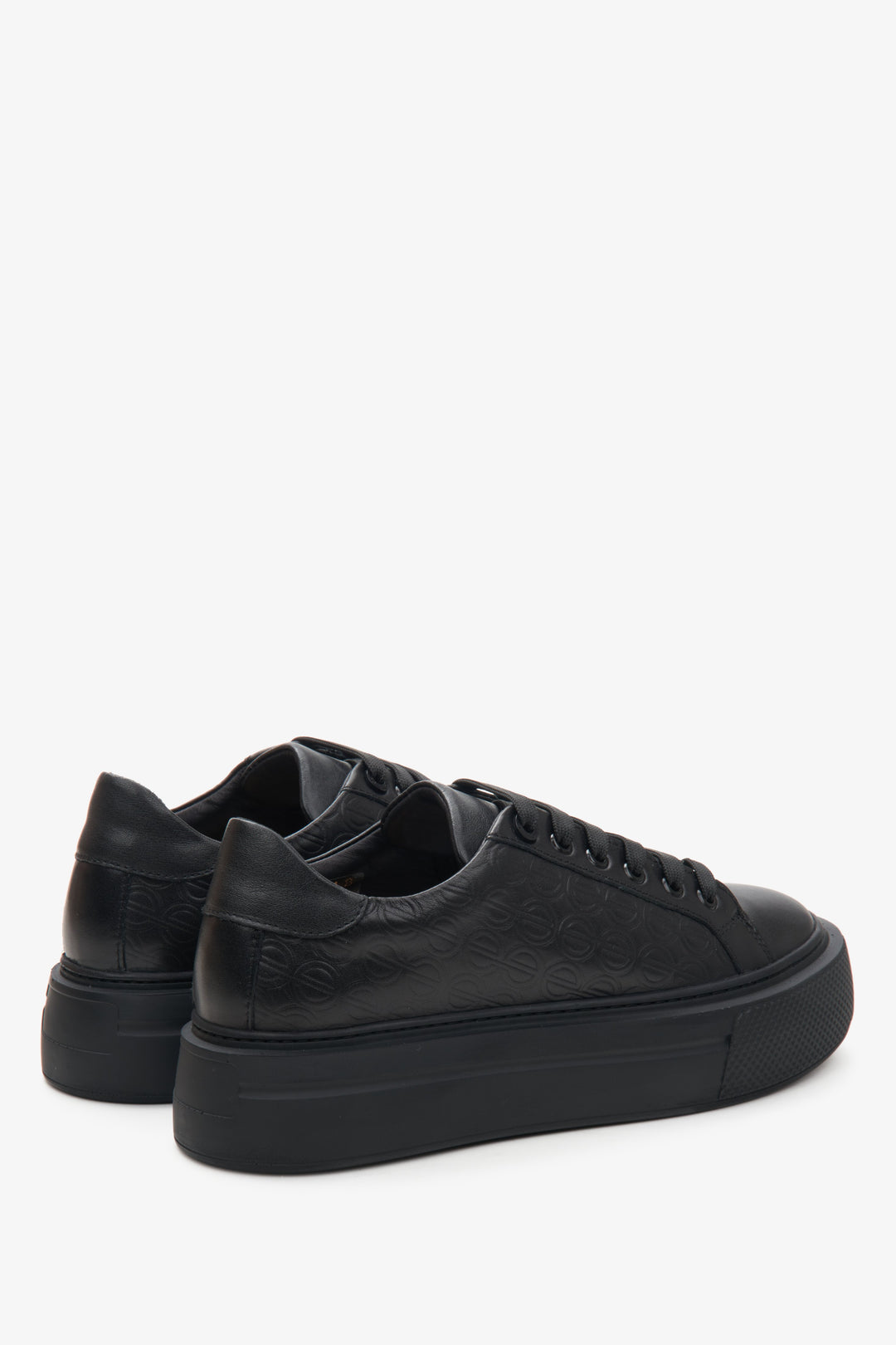 Women's black leather sneakers by Estro - close-up on the side line and heel counter.