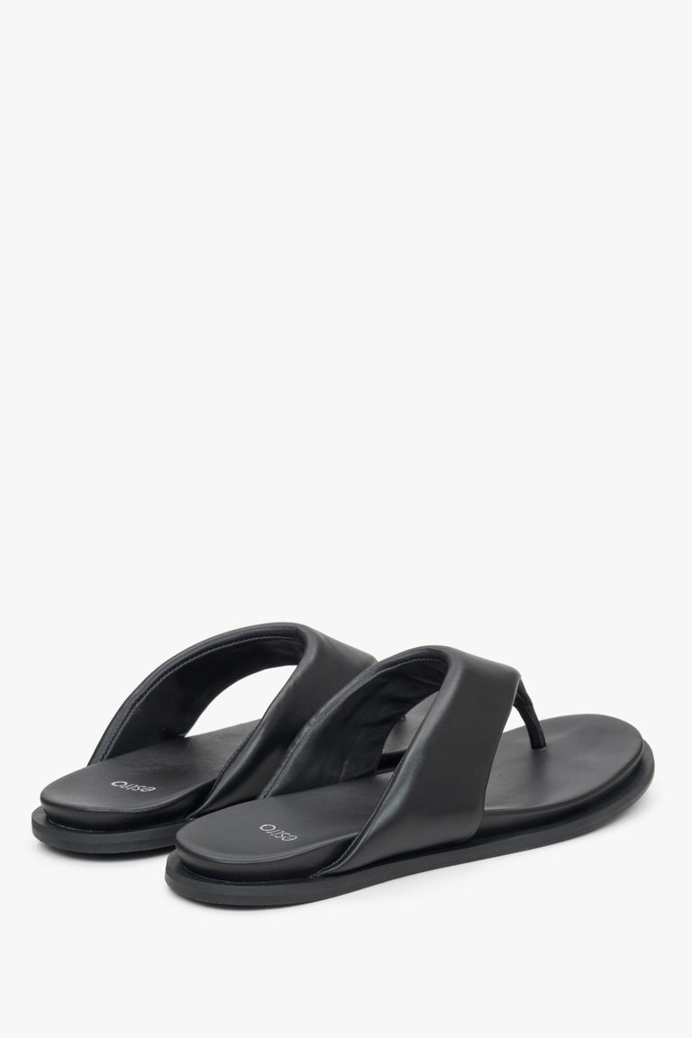 Estro women's black slide sandals - close-up on the heel strap and side profile of the shoe.