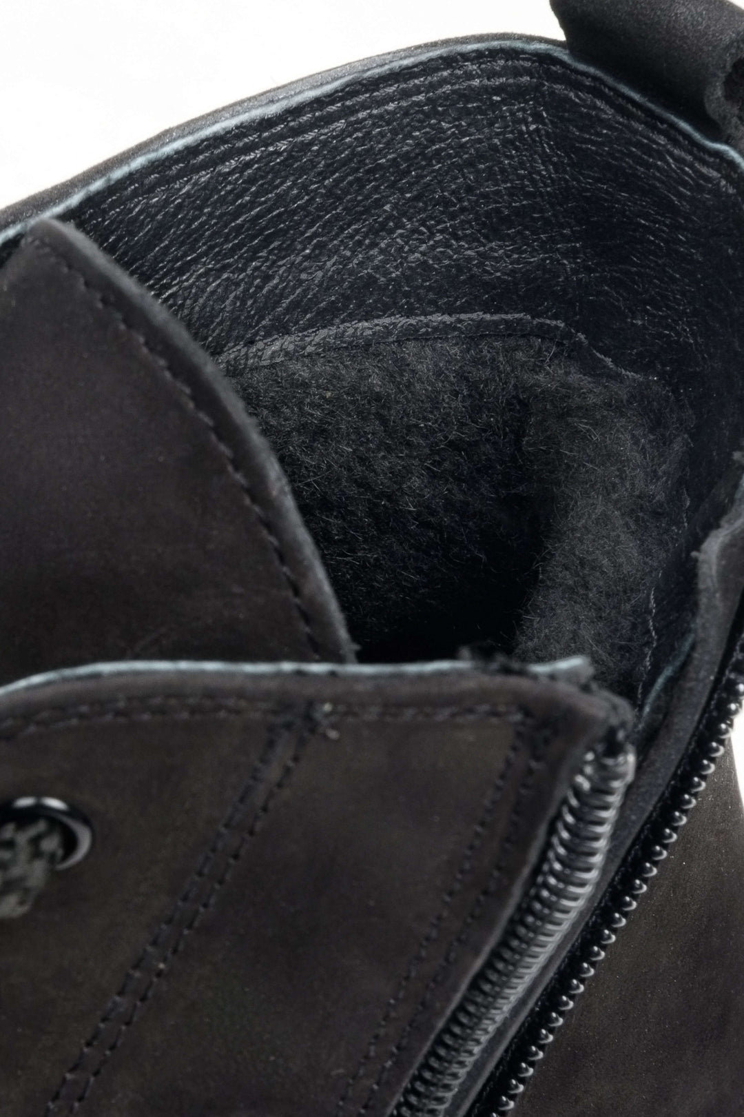 High-top men's sneakers in black - close-up on the shoe's padding.
