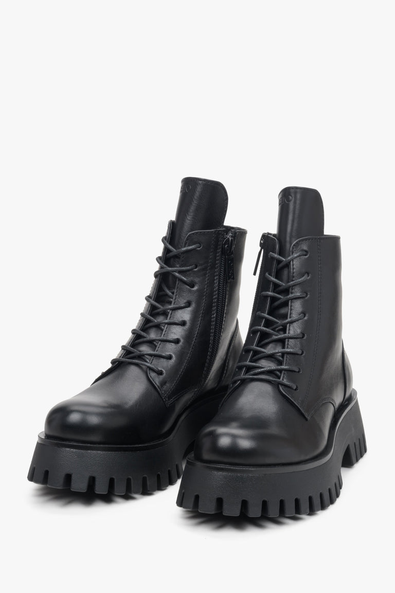 Leather black Estro women's boots with decorative lacing - close-up on the toe of the shoe.