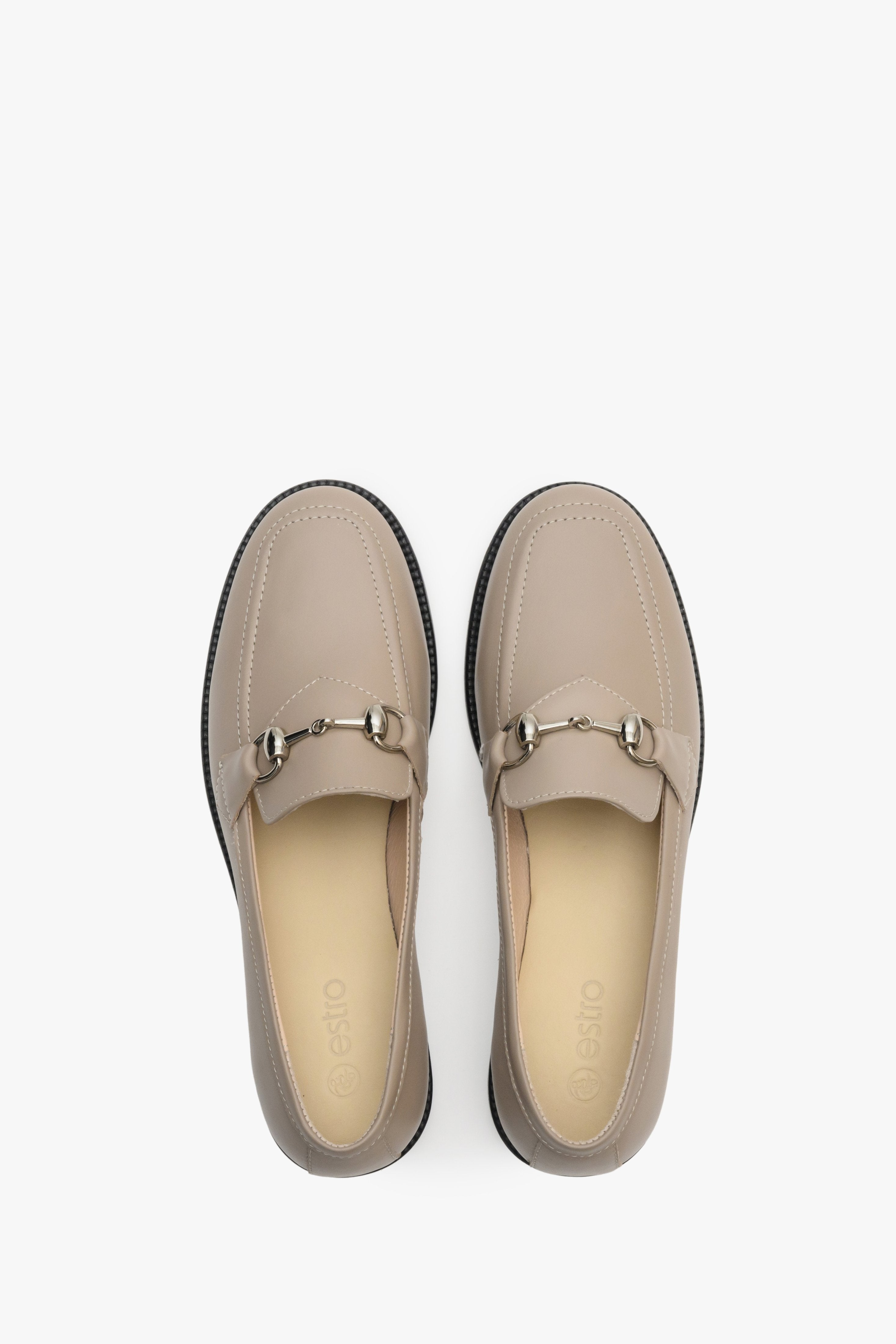Elegant, beige women's loafers made of Italian leather - close-up form above. 