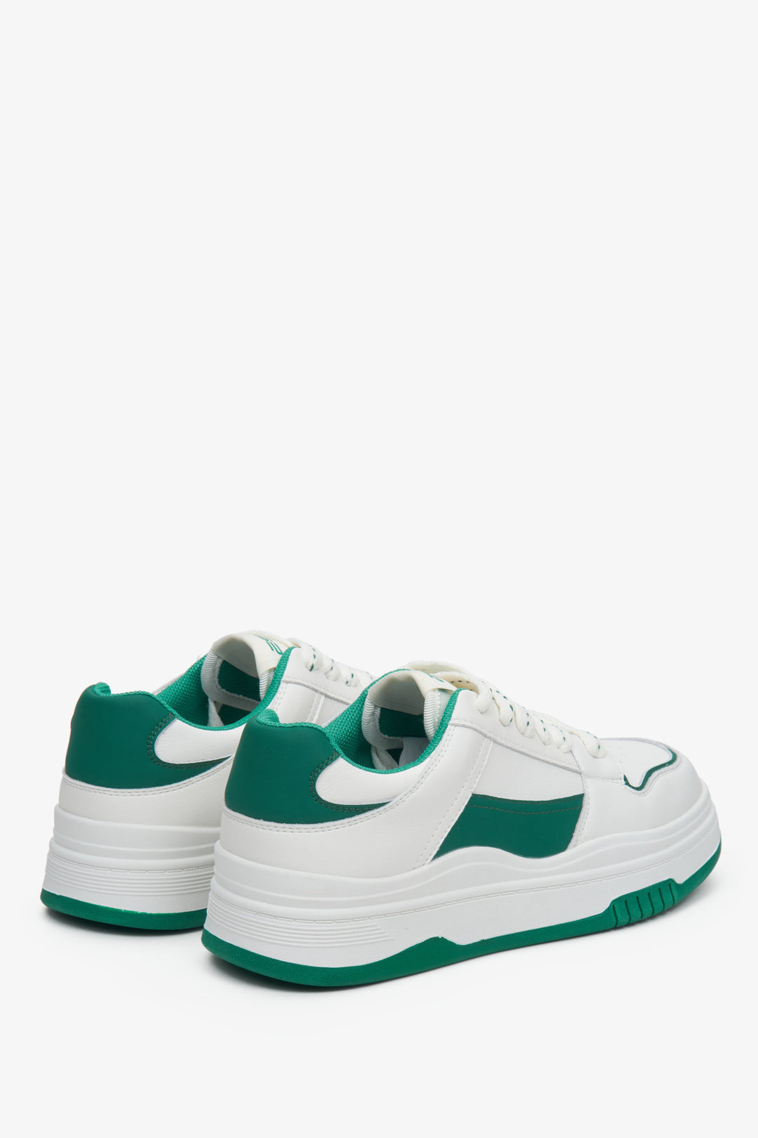 Women's green and white sneakers made of leather.