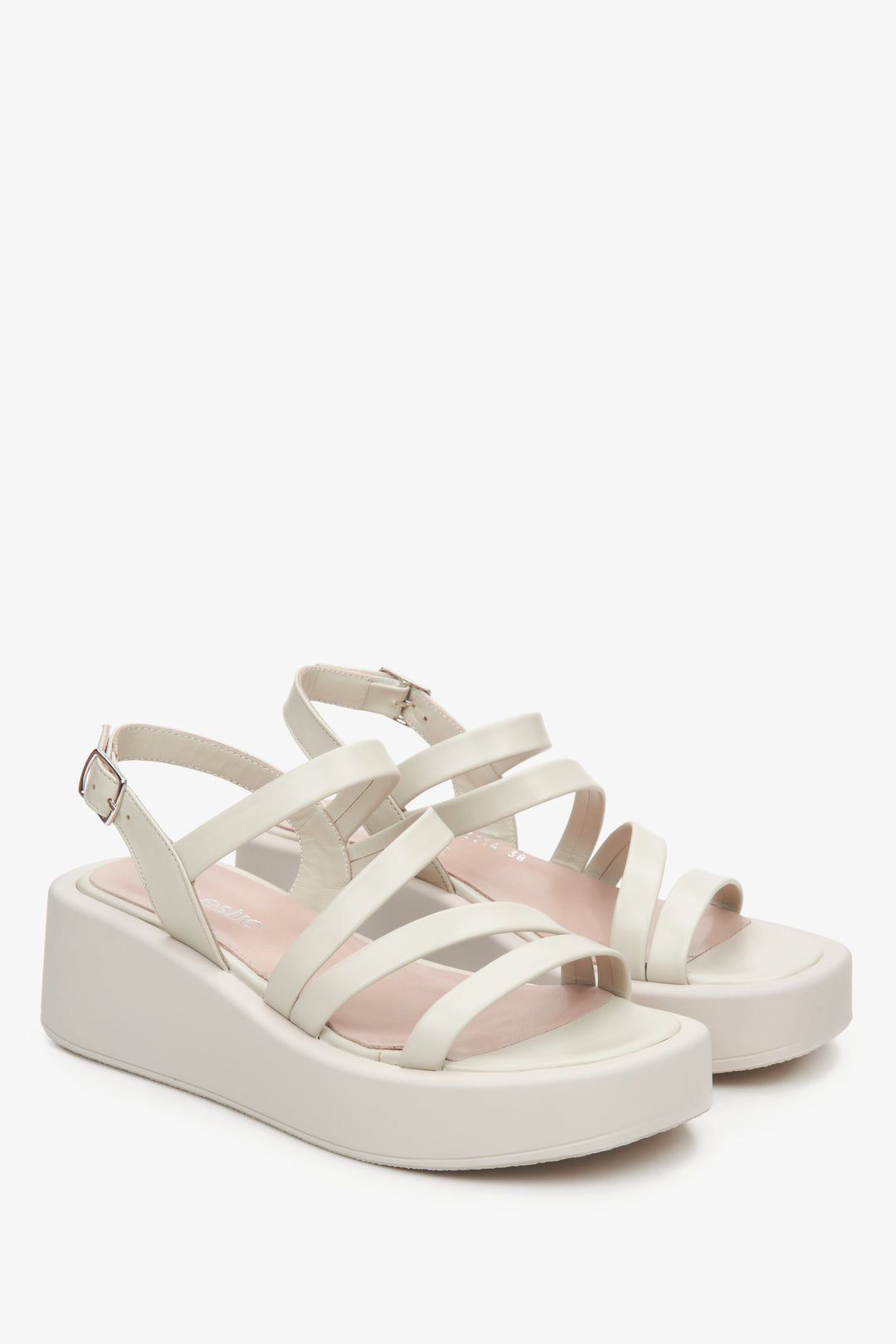 Women's leather wedge sandals by Estro in light beige colour.