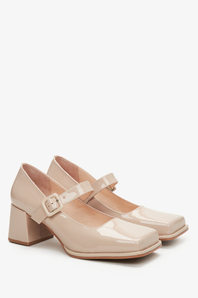 Women's beige leather patent Mary Jane pumps.